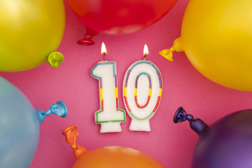 Happy Birthday number 10 celebration candle with colorful balloons