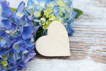 blue flower and wooden heart lying on wood - 164286424