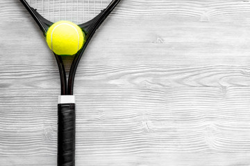 tennis racket on wooden background top view