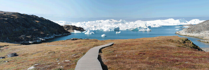 a wooden walkway towards Ilulissat Ice Fjord (jakobshavn) near Ilulissat in Summer
