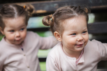 Identical twin toddler girls smiling