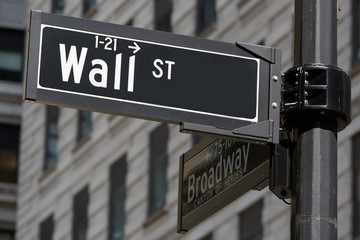 Wall Street and Broadway sign near Stock Exchange, financial district in New York in a sunny day