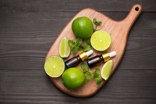 Natural cosmetics for home spa. Bottle of essence oil with fresh limes