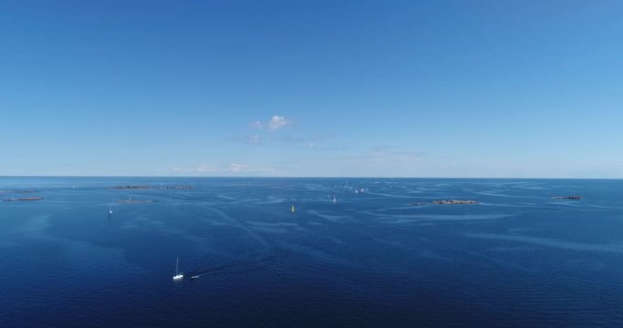 Sailboat regatta, Cinema 4k aerial view above a lot of sailboats on the baltic sea and heading towards hanko city, out on the  finnish archipelago, turquoise sea, on hango regatta day