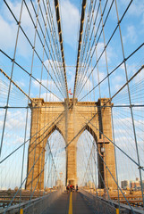 Portrait image of the famous Brooklyn bridge in warm sunlight