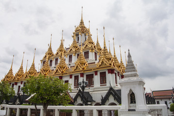 Fototapeta na wymiar Loha Prasat Wat Ratchanatdaram in Bangkok Thailand which means iron castle or monastery is composes of five towers, of which the outer, middle and the center tower contain large black iron spires. 