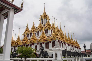 Fototapeta premium Loha Prasat Wat Ratchanatdaram in Bangkok Thailand which means iron castle or monastery is composes of five towers, of which the outer, middle and the center tower contain large black iron spires. 