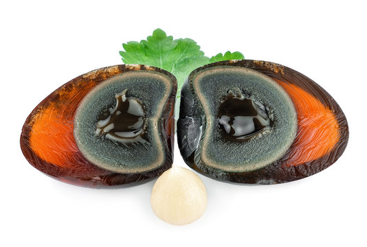preserved duck eggs and galic on white background