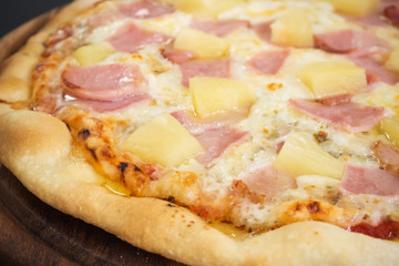 Fresh homemade pizza. Hot from oven. Hawiian pizza. Favorite taste for lover ham and pineapple.