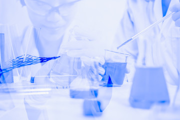 Double exposure Scientists mixing chemicals in the lavatory as part of an experiment with new substances