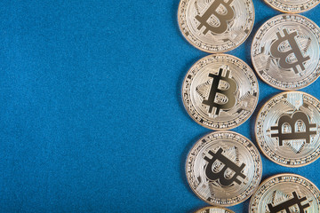 Obraz na płótnie Canvas Golden Bitcoins (digital virtual money) on blue background.