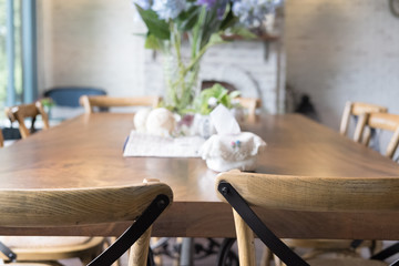 wood table and chair in dining room beside window. home interior