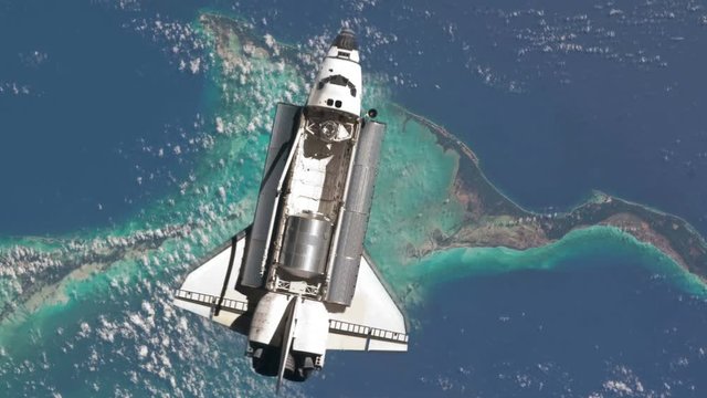 Closeup view of the Space Shuttle in orbit over Earth.