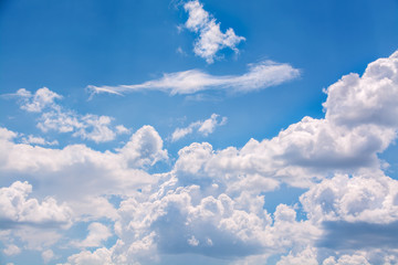 White curly clouds in a blue sky. Sky background