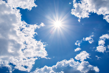 Sun rays against a blue sky in the clouds