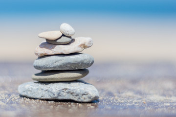 Fototapeta na wymiar Stones balance on blue background sea. А balance with nature.