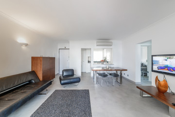 Modern apartment with white walls and light grey floor