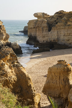 Cliffs with empty beach in Algarve at south of Portugal