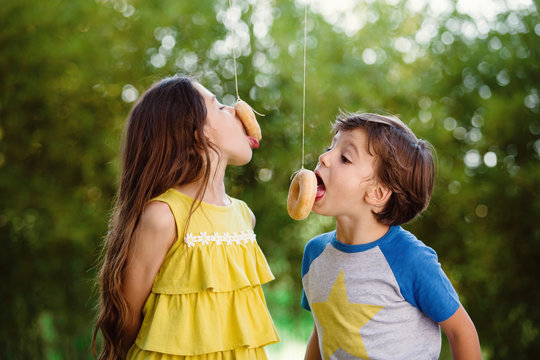 kids eating donuts on a string
