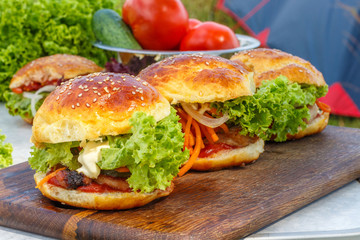 Burgers on a wooden Board .
