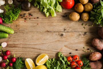 Fresh farm market vegetables, organic fruits and greens on rustic wooden background. Top view with...
