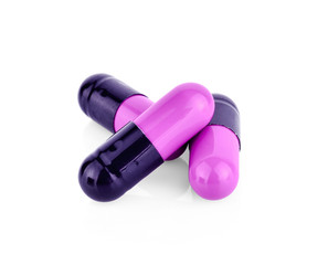 Purple pill capsule isolated on white background