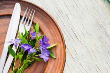 Festive Table setting with purple flowers.
