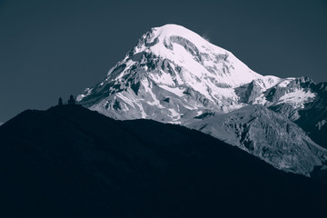 Stunning mountain landscape. Mount Kazbek with Gergeti church silhouette, Stepantsminda, Georgia. Europe. Famous tourist attraction. Climbing concept. Black and white. Adventure holiday. Ecotourism