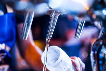 Detail of a bartender brewing a beer Detail of a bartender brewing a beer Detail of a bartender...