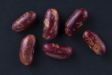 Some fresh red beans closuep on the black background.