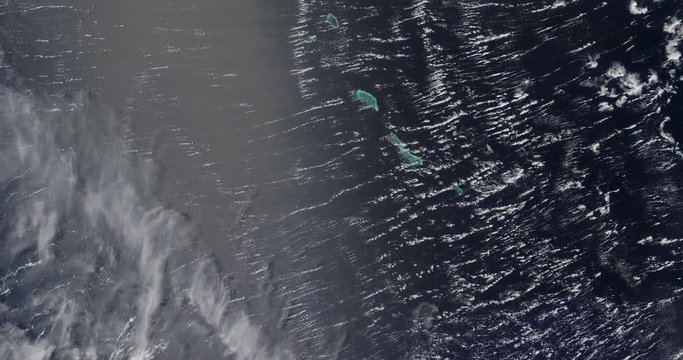 Very high-altitude overflight aerial of the remote Gilbert Islands in the central Pacific Ocean. Clip loops and is reversible. Elements of this image furnished by USGS/NASA Landsat