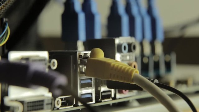 Network card with cable in motherboard with razer on a background. Flashing lamp, signal presence