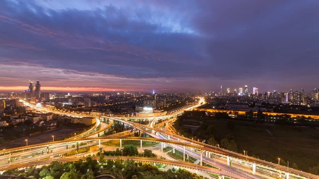Time lapse of the busy interchange traffic in city from day to night