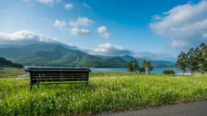 Obraz premium Scenic Of Mountain , Lake View And Wooden Bench In Hokkaido, Japan