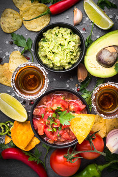 Latinamerican food party sauce guacamole, salsa, chips and tequi