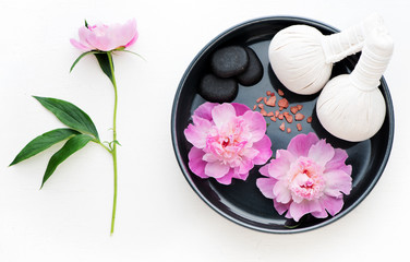 Fototapeta na wymiar Spa massage set. Thai herbal balls, zen stones and flowers