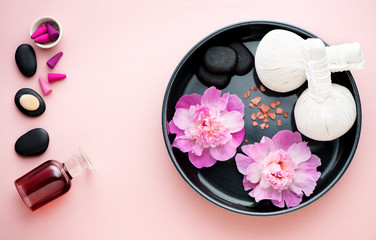 Obraz na płótnie Canvas Spa massage set. Thai herbal balls, zen stones, essential oil and flowers