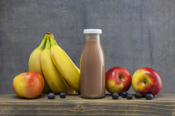 organic smoothie apple,bluberry and banana juice glass on wood