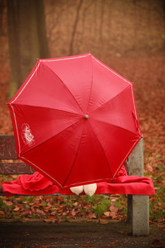 Girl in park with umbrella.