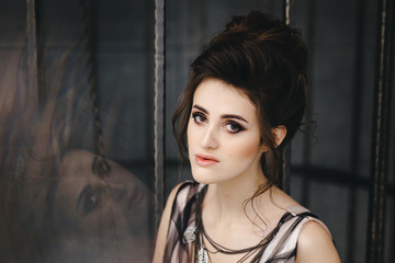 Portrait of a beautiful brunette with bright makeup on a dark background. fashion woman.