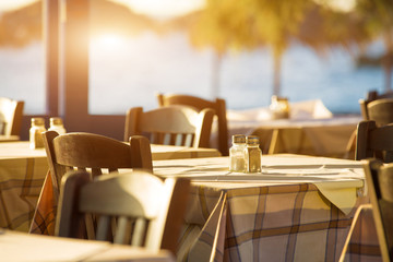 Outdoor cafes in coastline resort Kamari in Santorini Greece