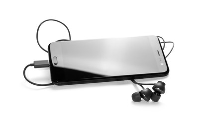 Black smartphone with blank screen and earbuds isolated on a white background, top view