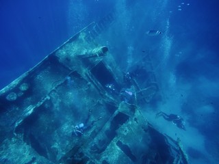 Divers exploring a wreck, Pomonte, Elba island, Italy