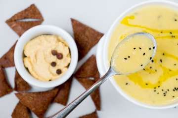 Soup-cheese with broccoli in a white plate on a white background