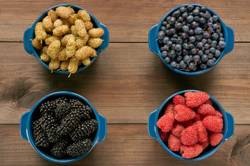 four bowls with berries