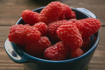 closeup of ceramic bowl with raspberries