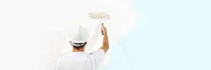 painter man at work with a paint roller isolated , web banner, wall painting concept