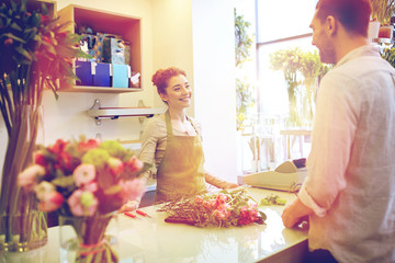 smiling florist woman and man at flower shop
