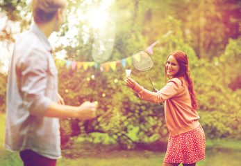 Naklejka na ściany i meble happy friends playing badminton at summer garden