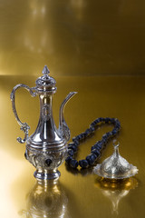 Ramadan, silver Turkish coffee pot on a gold background